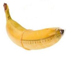 Banana in a condom simulates a big cock